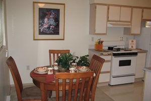 kitchen and dining area, white cabinets and white appliances