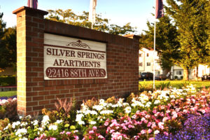 Silver Springs Apartments 22416 88th Ave S brick sign, flowers