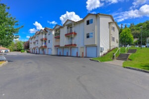Exterior residential building, garage parking available, parking lot.